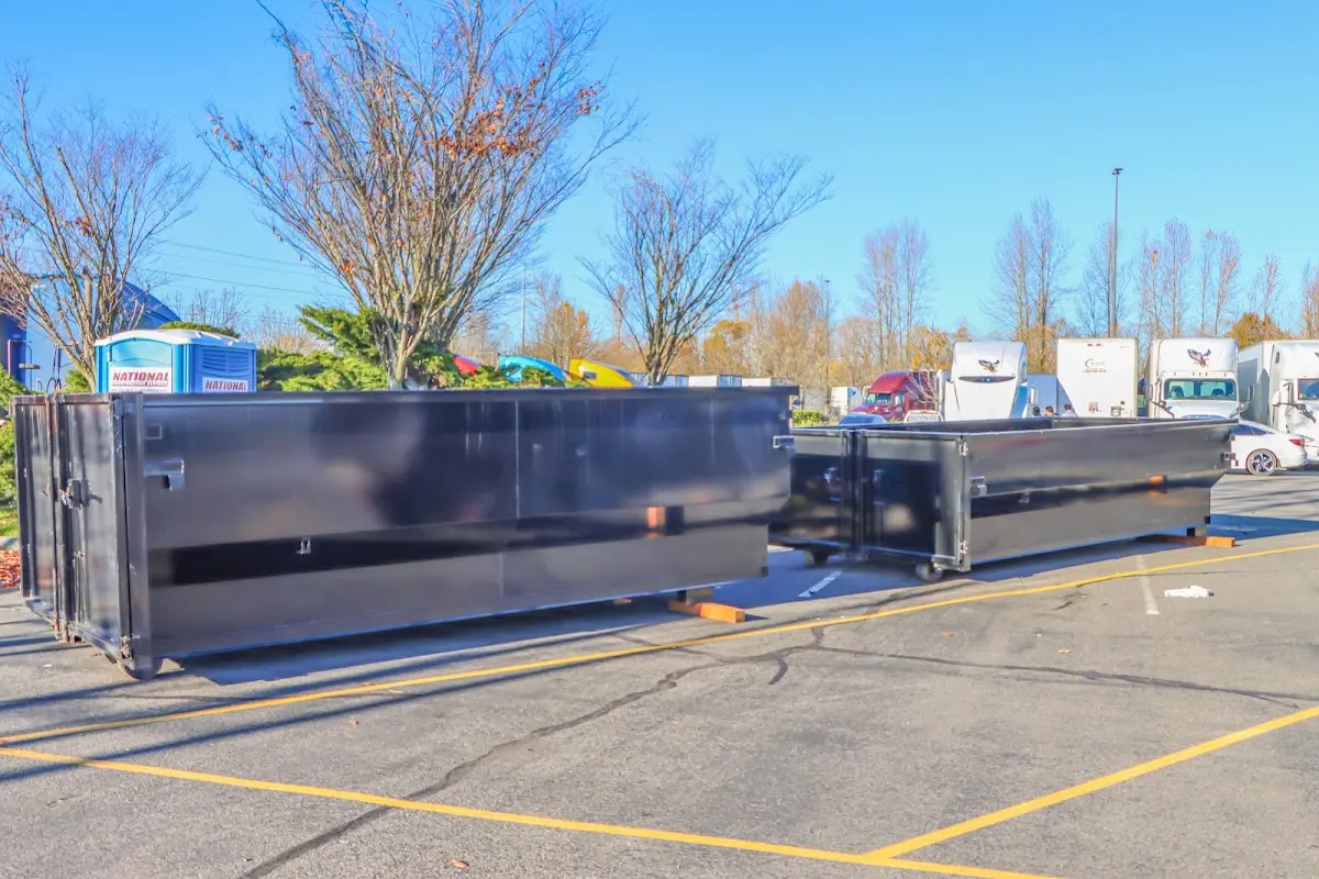 Professional dumpster rental service with roll-off container on residential driveway in Oldsmar